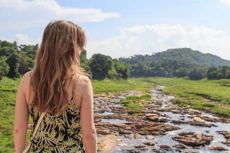 Back view cute female traveler in exotic placeの写真素材