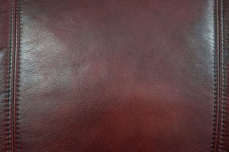 Close up dar red leather texture backgroundの写真素材