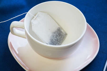 Tea bag put in white ceramic teacupの写真素材