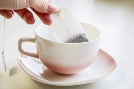 Tea bag put in white ceramic teacupの写真素材