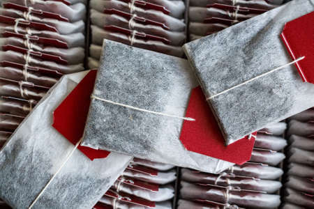 Close up tea bags with red labels in boxの写真素材