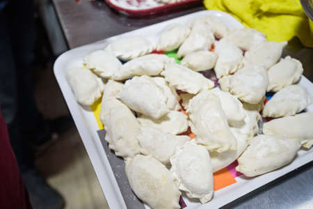 Cooking traditional Russian dumplings vareniki
