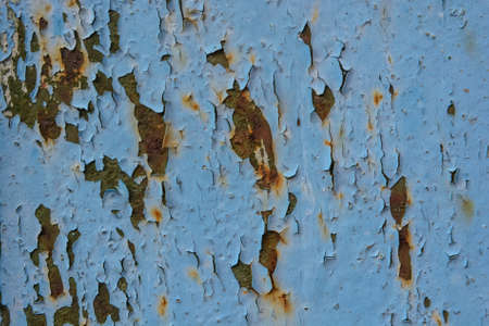 Blue cracked painting on wooden surface