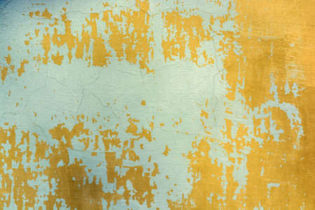 Blue cracked painting on old plaster wall surfaceの写真素材