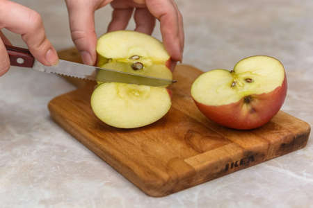 Cutting apple into halfsの写真素材