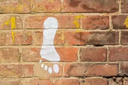 Human footprint on brick wallの写真素材