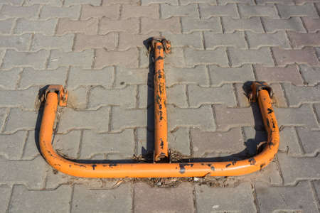 Orange parking barrier on pavementの写真素材