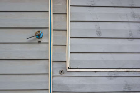 Grey vinyl siding wall and door close upの写真素材