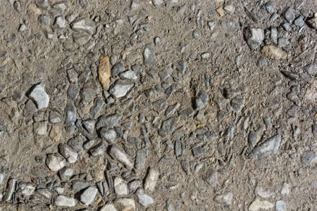 Abstract background of closeup dark uneven asphaltの写真素材