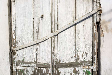 Old boarded-up window on brick wallの写真素材