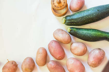 Top view of fresh potatoes and cucumbersの写真素材