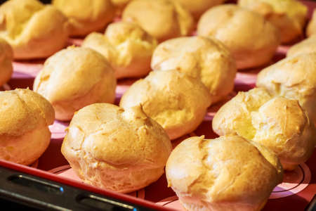 Baked profiteroles on trayの写真素材