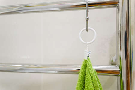 Close up green towel hangs in bathroomの写真素材