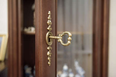 Close up vintage key in keyholeの写真素材