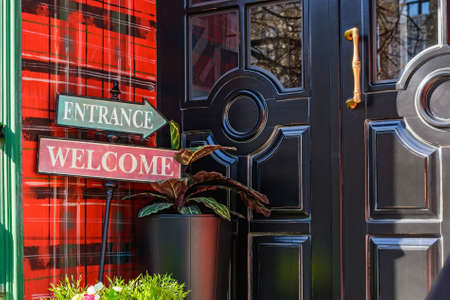 Close up wooden entrance door with welcome signの写真素材