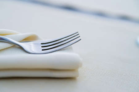 Close up fork on white napkin in restaurantの写真素材