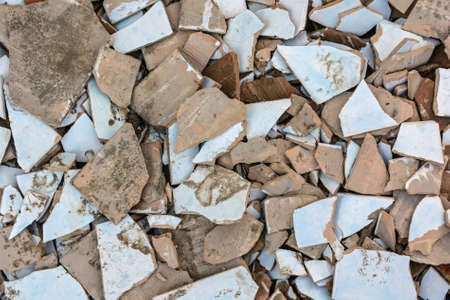 Pieces of old crashed tiles on ground close upの写真素材