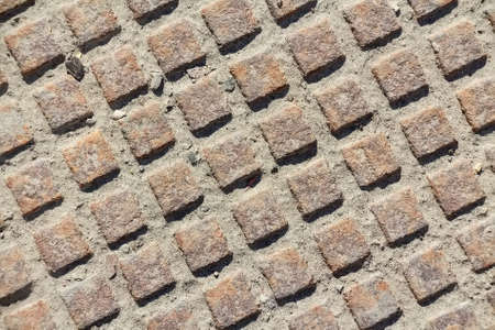 Close up metal grid pattern of manholeの写真素材