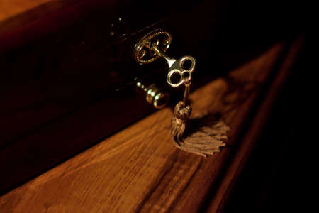 Close up vintage key in keyholeの写真素材