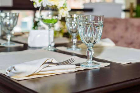 Elegant served table with wine glasses in modern restaurantの写真素材