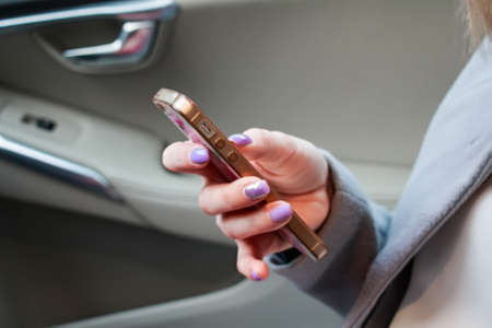 Close up womans hands hold smartphoneの写真素材