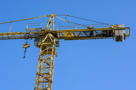 Close up construction crane builds new buildingの写真素材