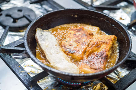 Close up fried fish fillet on panの写真素材