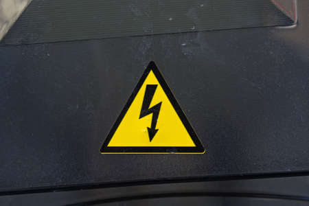 High voltage sign on black surfaceの写真素材
