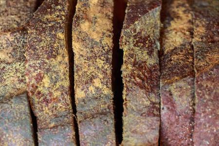 Slices of old moldy rye bread on wooden shelfの写真素材