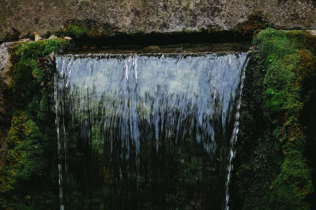 Close up waterfall with green moss in backgroundの写真素材