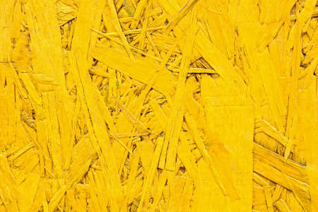 Close up bright yellow particle board surface