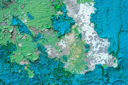 Blue cracked painting on old plaster wall surfaceの写真素材