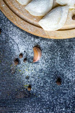 Single garlic clove on dark wooden backgroundの写真素材