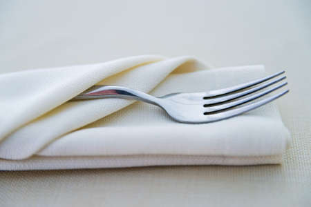 Close up fork on white napkin in restaurantの写真素材