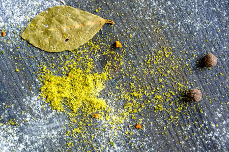 Yellow curry powder on dark wooden backgroundの写真素材