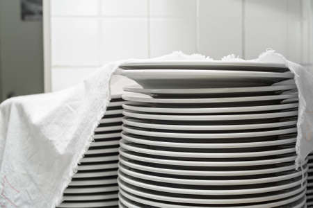 Stack of clean white ceramics platesの写真素材