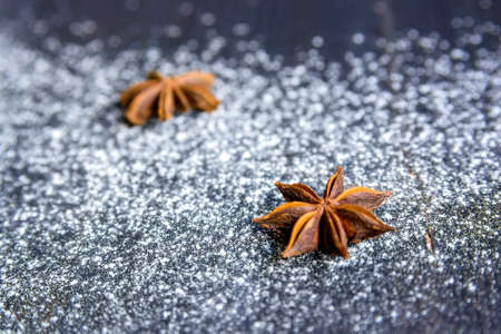 Star anise and flour on dark wooden backgroundの写真素材