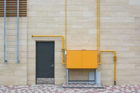 Orange electric box outside modern buildingの写真素材