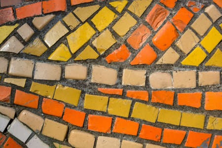 Bright orange tile in stone wall
