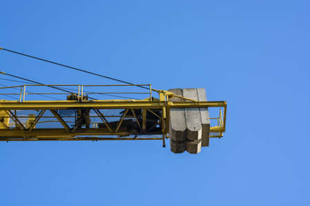 Close up construction crane builds new buildingの写真素材