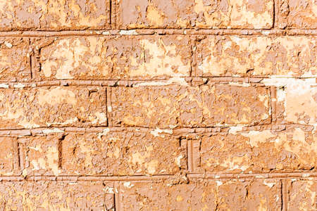 Brown cracked painting on brick wallの写真素材