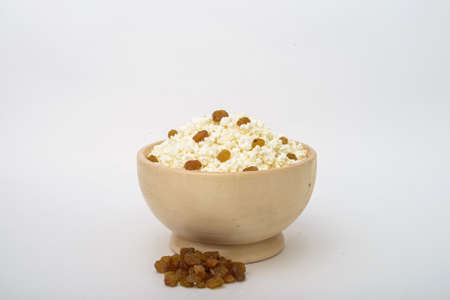 Cottage cheese with raisins in wooden bowlの写真素材