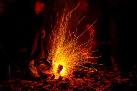 Closeup people around bonfire slow shutter pictureの写真素材