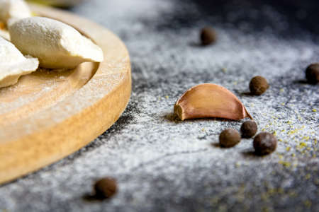 Single garlic clove on dark wooden background
