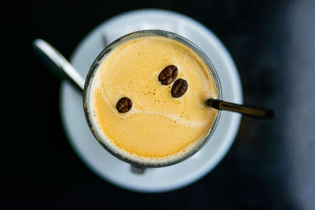 Top view cup of coffee decorated with coffee beansの写真素材