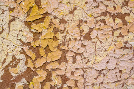 Beige cracked painting on plaster surfaceの写真素材