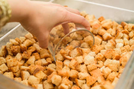 Scooping home made croutons in glassの写真素材