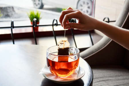 Tea bag put in transparent glass teacupの写真素材