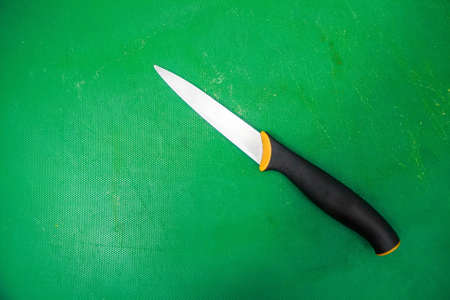 Modern knife on green backgroundの写真素材