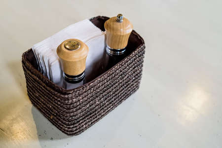 Closeup salt and pepper bottles restaurant tableの写真素材